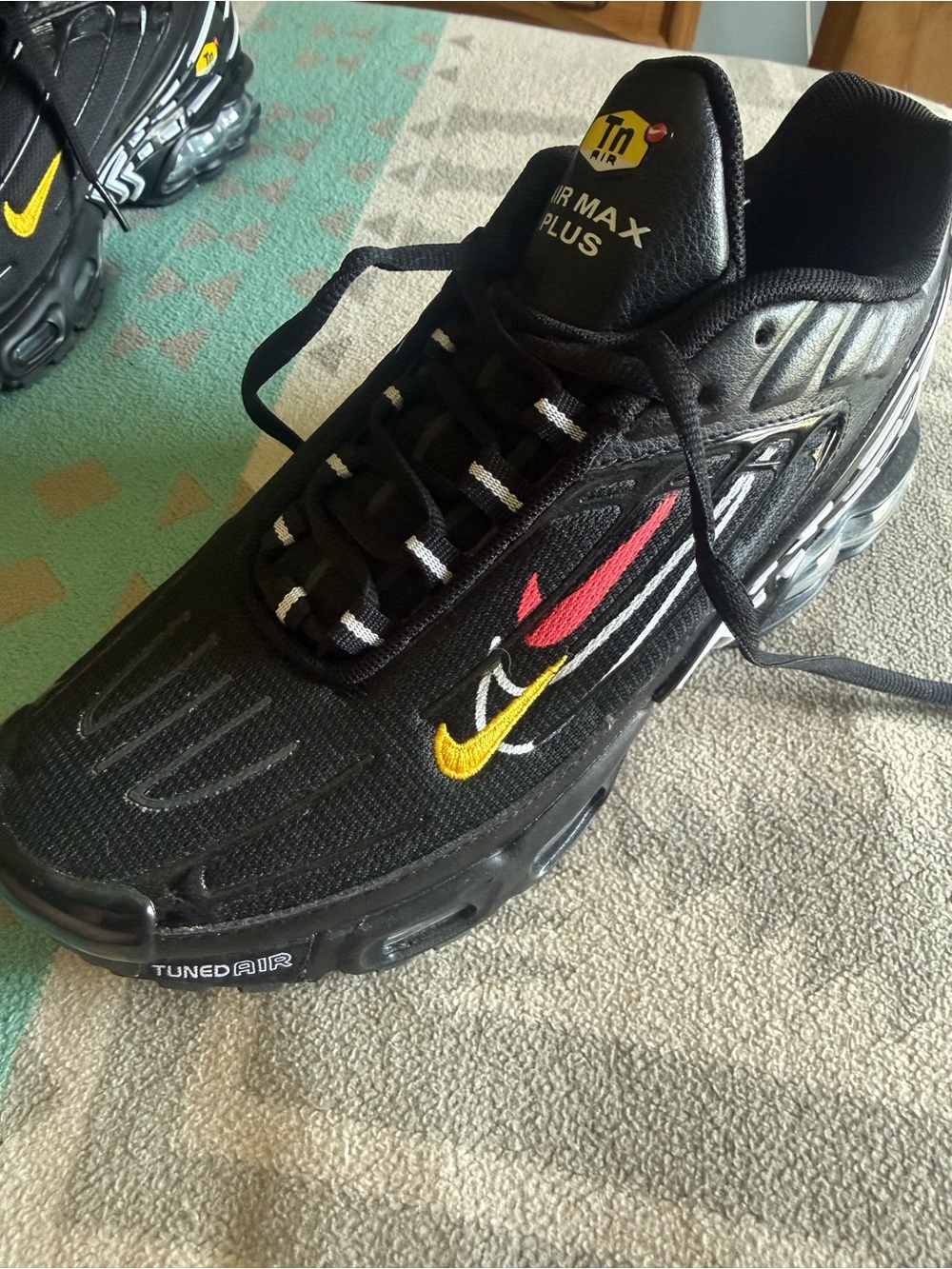 Nike Men's Black Sneakers with Yellow and Red Swoosh Accents